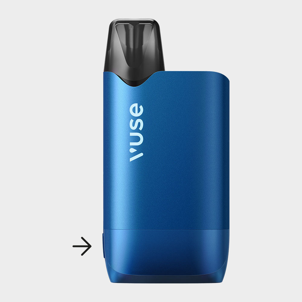 A blue Vuse vape device with a black mouthpiece is shown upright against a white background. An arrow points to a small button or indentation near the devices base on the left side.